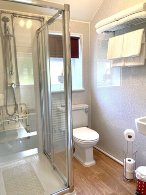 Shower, hair dryer, towels, toilet paper