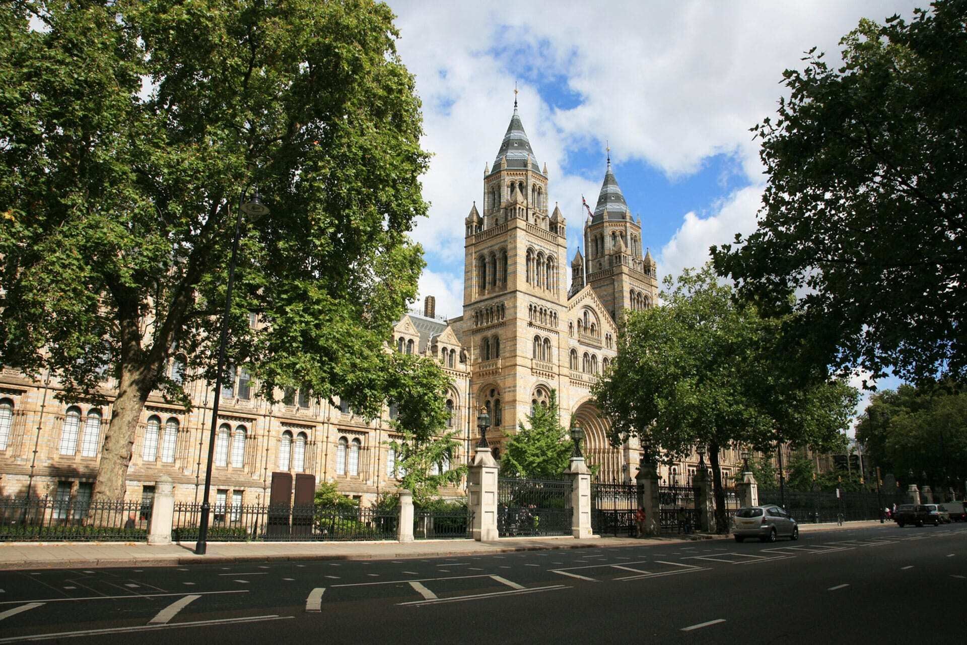 A large, historic building with Gothic architecture, featuring multiple towers and arched windows.