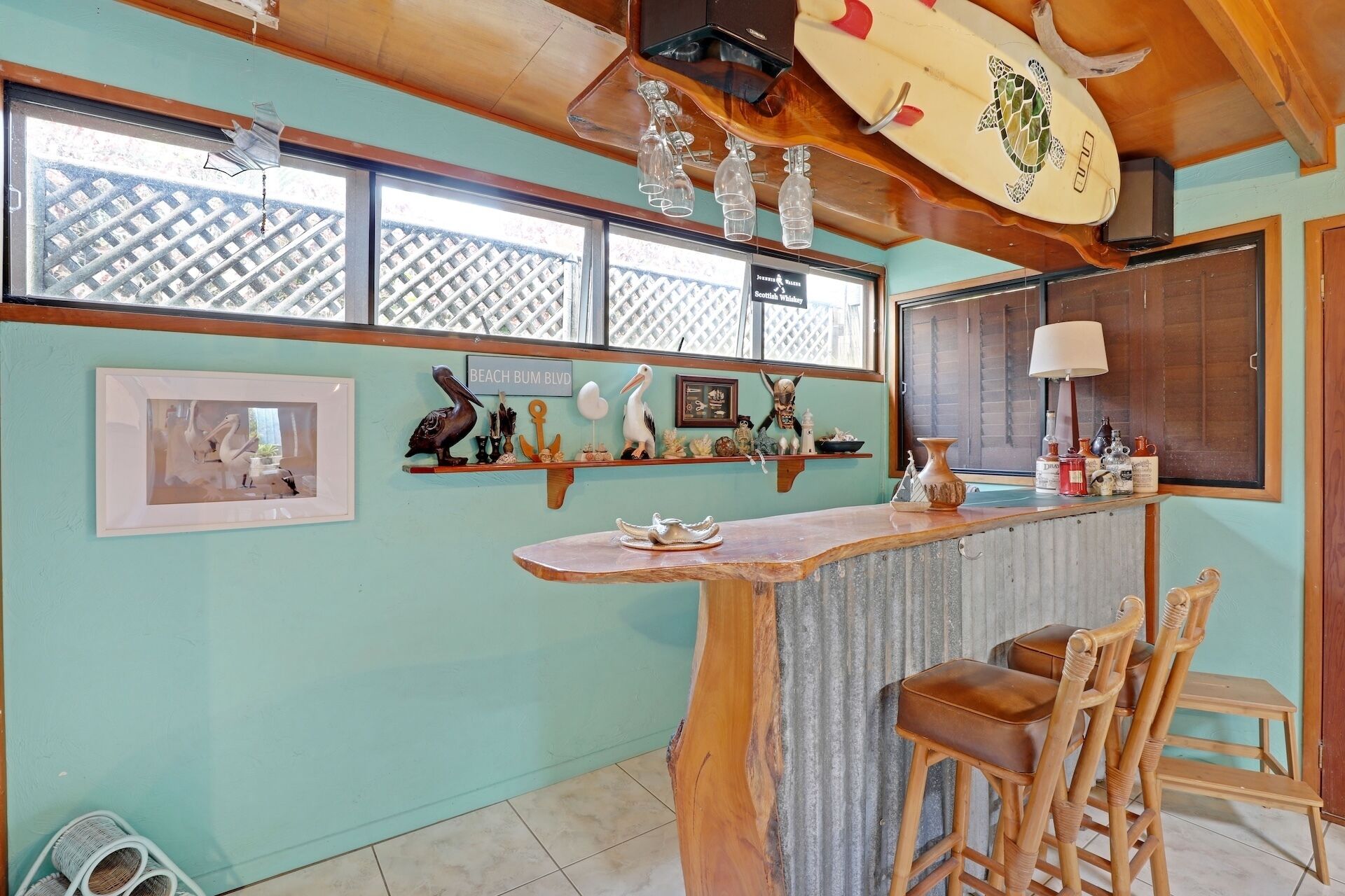 A bar area with wooden chairs, a counter, and various decorative items on shelves.