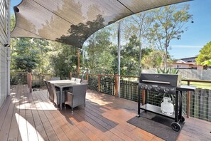 An outdoor patio with a grill, wicker furniture, and a covered area. - Contemporary 2 storey home, Central Location. (Amity Point)