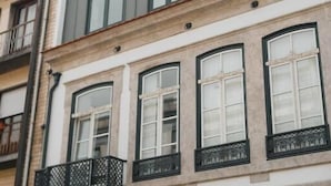 A multi-story building with a modern facade, featuring large windows and decorative arches.