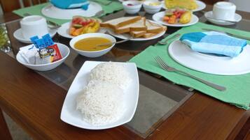 A dining table with various dishes including rice, soup, and vegetables.