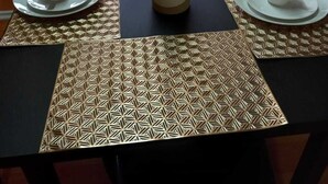 A dining table with two white cups and saucers, a potted plant, and a patterned table runner. - Lyn's Suite (Saint George)