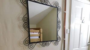A white cabinet with glass doors and a black ornate mirror above it. - Sygun Cottage 40 mins walk to Watkin Waterfalls, Snowdon (Beddgelert)