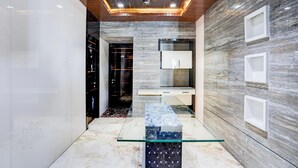 A modern kitchen with marble countertops, a glass-top island, and built-in cabinets. - Modern Comfort Stays at Swarop Nagar Kanpur (Kanpur)