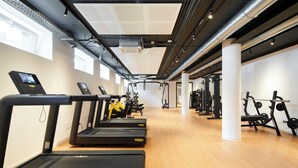 A gym with treadmills, weight machines, and a wooden floor. - aparto Milan Durando (Milan)