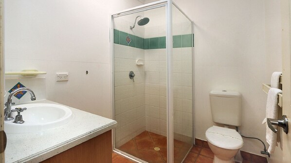 A bathroom with a shower, toilet, and sink. - Villa 7/1 Pebble Beach Drive Coral Cove (Coral Cove)