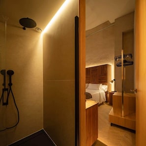 A modern bathroom with a shower, a toilet, and a bidet.