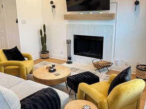 Smart TV, fireplace, books, computer monitors