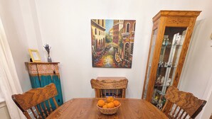 A wooden dining table with a bowl of oranges, surrounded by chairs with intricate carvings. - Cozy retreat home in Guelph. Pet-friendly! (Guelph)