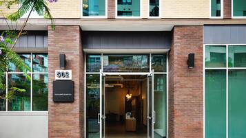 A building entrance with glass doors, a brick facade, and a sign indicating 'GASLAMP QUARTER.'