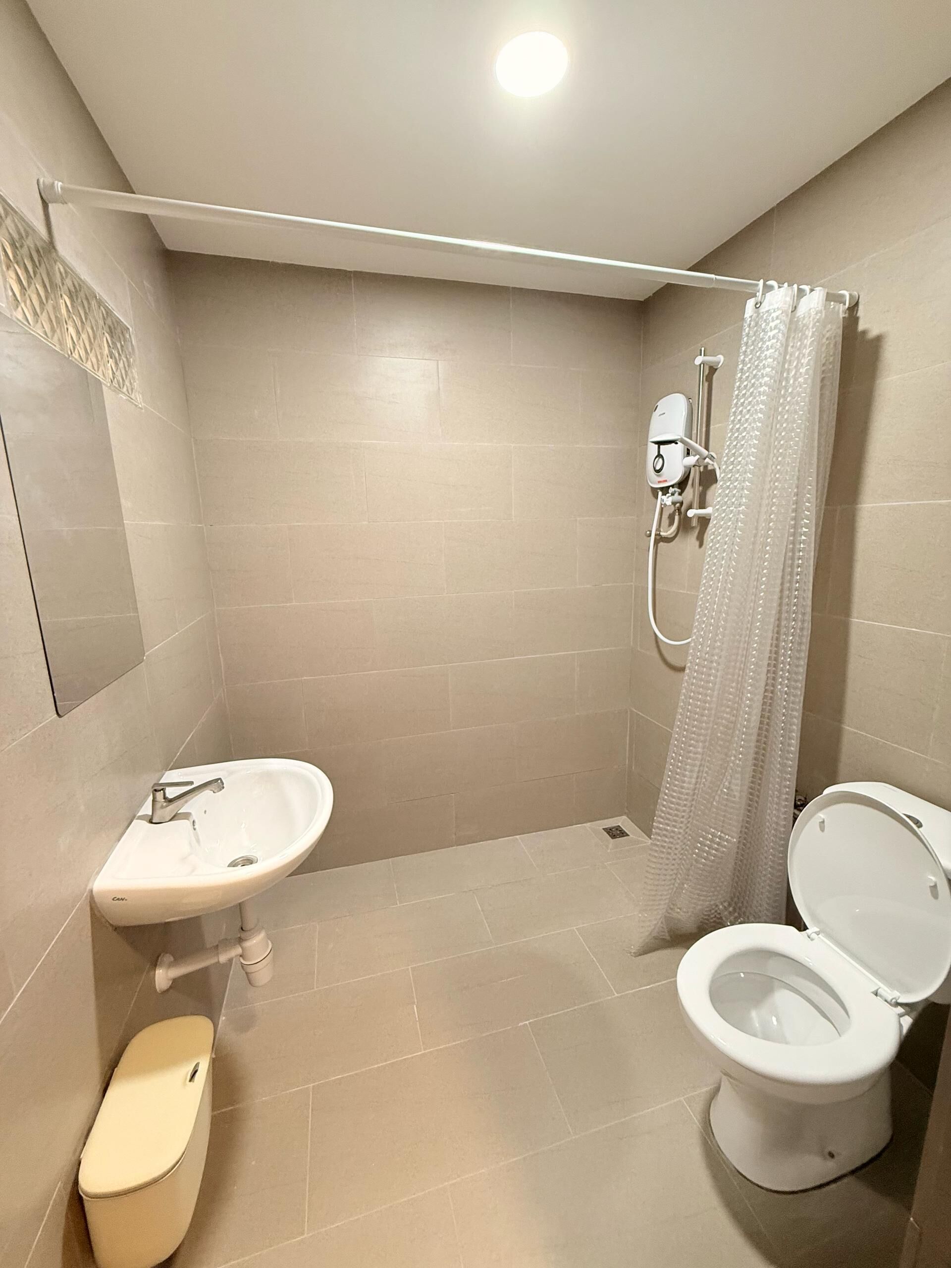 A bathroom with a shower, toilet, and sink.