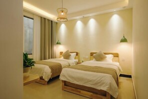 A hotel room with two beds, a large window with curtains, a potted plant, and wall-mounted lamps. - Shiguangli Homestay (Yangshuo West Street) (Yangshuo)