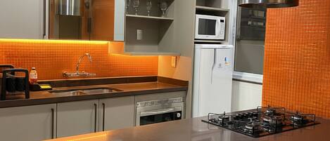 Een koelkast, een oven, een kookplaat, een koffiezetapparaat/waterkoker