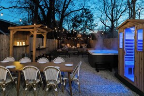 An outdoor patio with a wooden pergola, a hot tub, and a bar area. - Spacious Lux Cincinnati Group Retreat: Sauna/Spa, Fire pit, 5 min DT (Cincinnati)