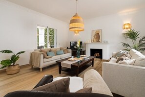 A living room with a sofa, coffee table, and a fireplace.