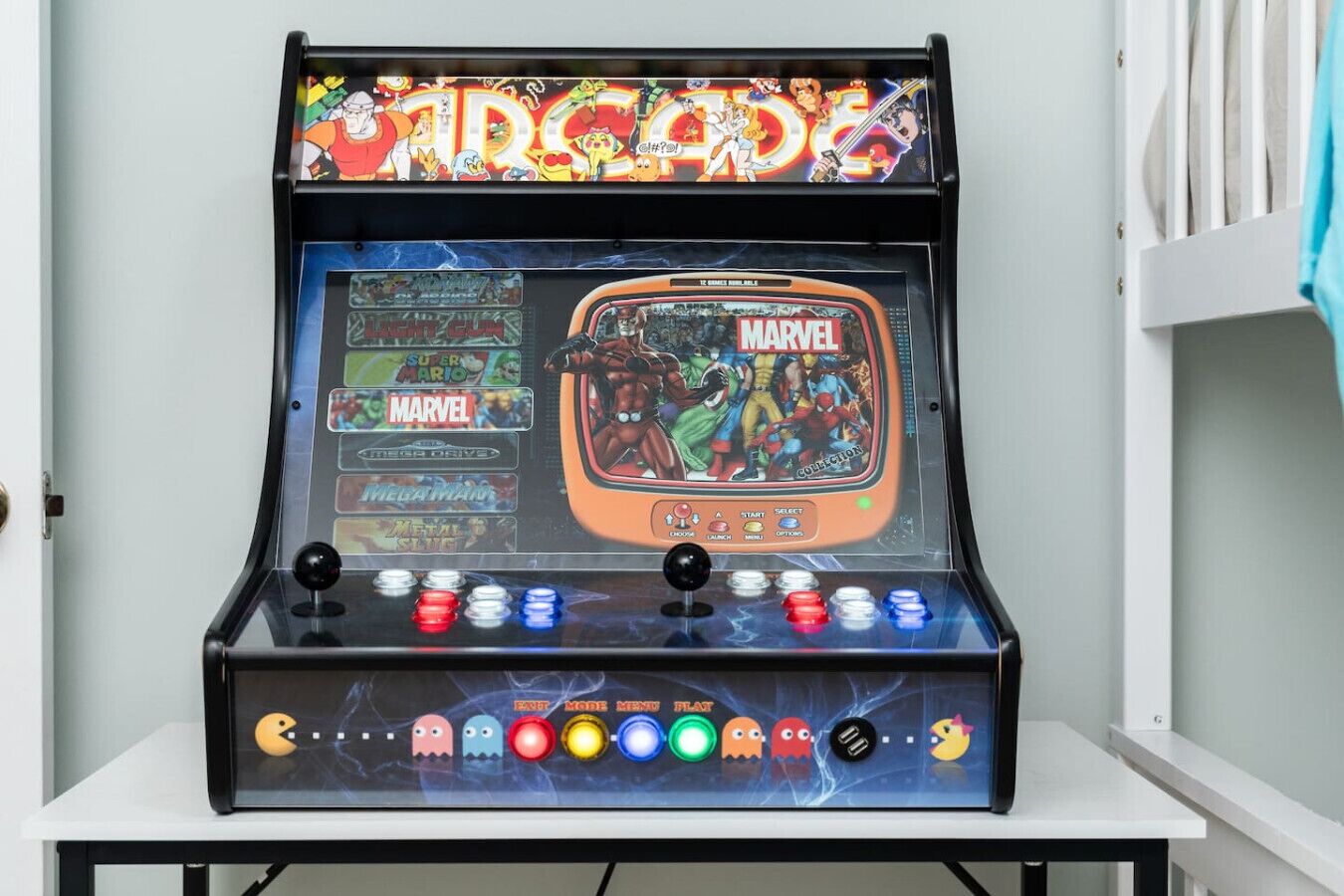 A vintage arcade machine with a MARVEL theme, featuring multiple game options and colorful buttons.