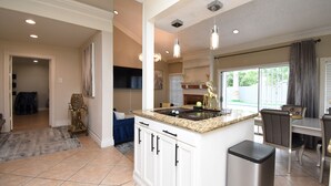 A kitchen with a granite countertop, white cabinets, and a stainless steel trash can. - EXOTIC LODGE
Discover a unique retreat experience in the heart of Houston, TX (Houston)