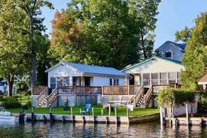 A waterfront house with a dock, a covered porch, and a small deck. - Riverside Escape | Perfect for Families & Friends (Indian River)