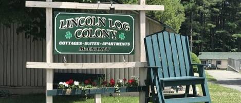 A sign for Lincoln Log Colony, indicating it offers cottages, suites, and apartments.