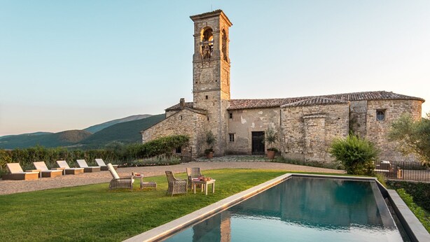 A stone building with a tower, a swimming pool, and lounge chairs. - VILLA SOVRANA - Ten Bedroom Villa, Sleeps 20 (Perugia)