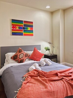 The first bedroom has a queen-sized bed with clean sheets and pillows
