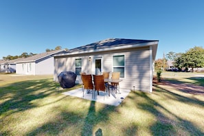 Enjoy a homey atmosphere on the covered patio with a barbecue grill and dining area.