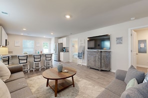 Relax in this stylish living space with a sofa, coffee table, and flat-screen TV.