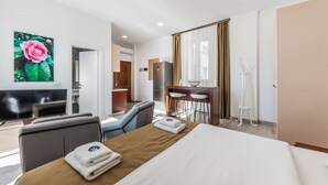 A hotel room with a bed, a desk, a TV, and a bathroom. - Studio with Amazing Balcony - Kamelia by PikHost (Gjiri i Lalzit)