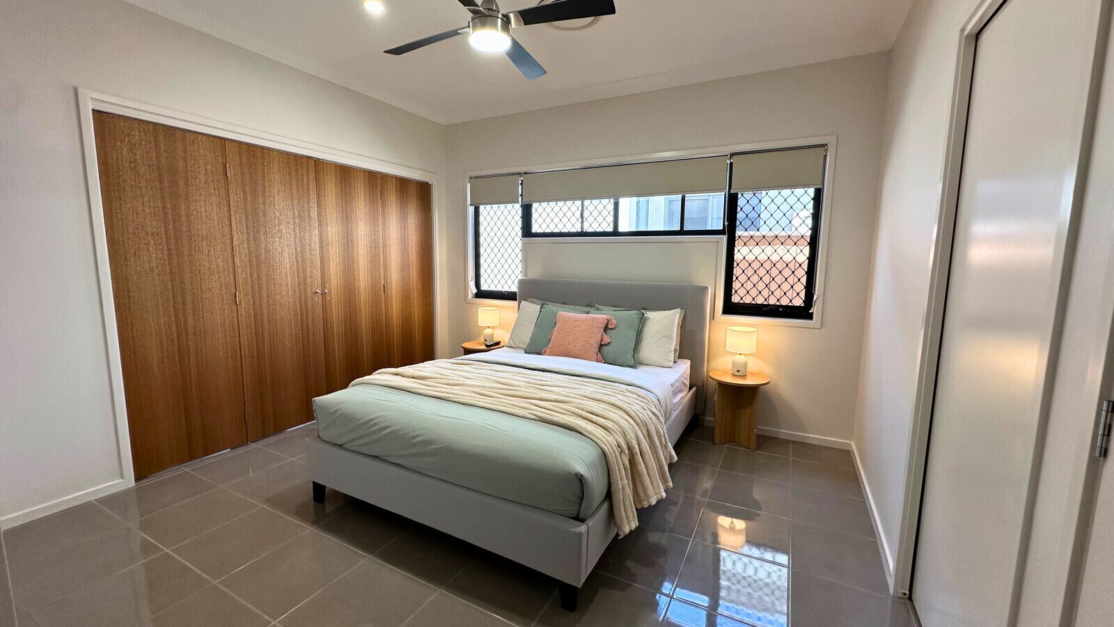 Relax in a cozy queen-size bed in the master bedroom with soft linen