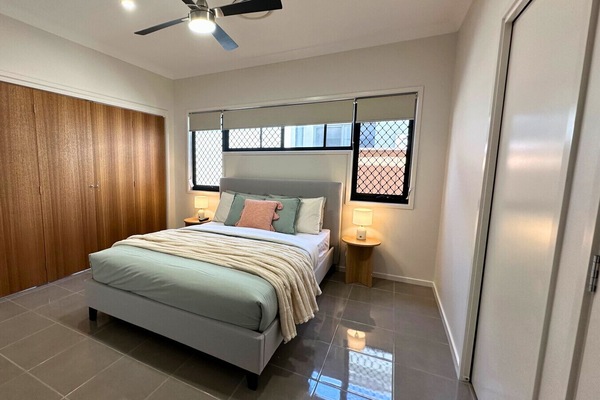 Relax in a cozy queen-size bed in the master bedroom with soft linen