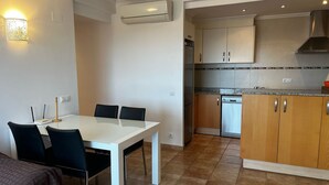 A modern kitchen with wooden cabinets, a built-in dishwasher, and a stainless steel range hood. - Jacaranda in Pedreguer (Pedreguer)