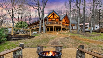 Guests can enjoy the outdoors from the large deck area, surrounded by trees and a clear view of the sky.