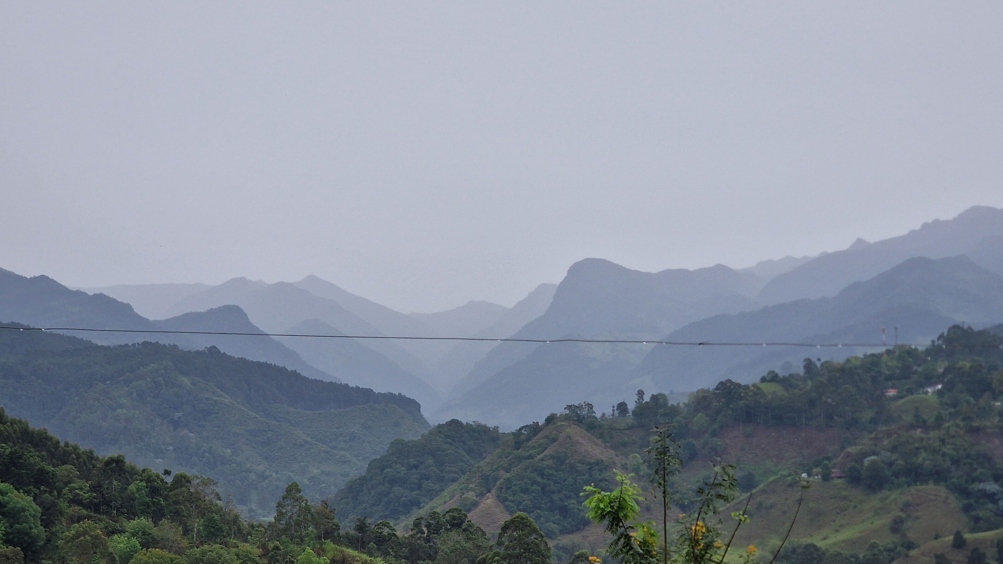 A mountainous landscape with a power line across the valley.