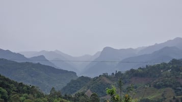 A mountainous landscape with a power line across the valley.