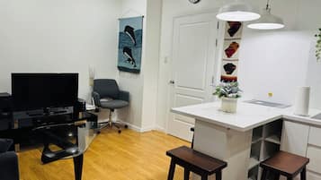 Family Double Room, Balcony, City View | Living area | TV