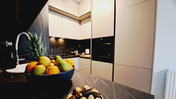A modern kitchen with a marble countertop, a bowl of fruit, and a plate of chocolates. - Apartment with self- check in, free private parking, WI-FI in brilliant Zagreb (Zagreb)