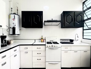 Cafetera o tetera, frigorífico, microondas y placa de cocina