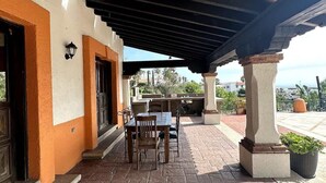An outdoor patio with a table and chairs, a pergola, and a view of the city. - Real Del Mar Tijuana  Apt for 2 guests (Tijuana)