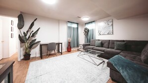 A modern living room with a sofa, coffee table, and a potted plant. - The Cloud off 16th  (Calgary)