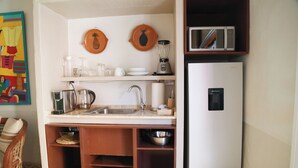 A compact kitchenette with a sink, microwave, blender, and a refrigerator. - Cazules #2 (Puerto Vallarta)