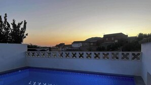 A rectangular pool with a blue interior and a white border, surrounded by a white wall with decorative cutouts. - Casasona, Alcaudete,jaen,housesleeps4- Pool-patio (Alcaudete)