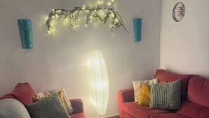 A living room with two red sofas, a coffee table, and a floor lamp. - Casasona, Alcaudete,jaen,housesleeps4- Pool-patio (Alcaudete)