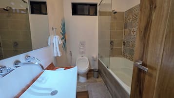Een badkamer met een bad, toilet en wastafel.