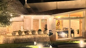 A building with a stone facade, a tiled roof, and a well-lit entrance. - Holiday Home 'Buontempo' with Private Pool, Wi-Fi and Air Conditioning (Francavilla Fontana)