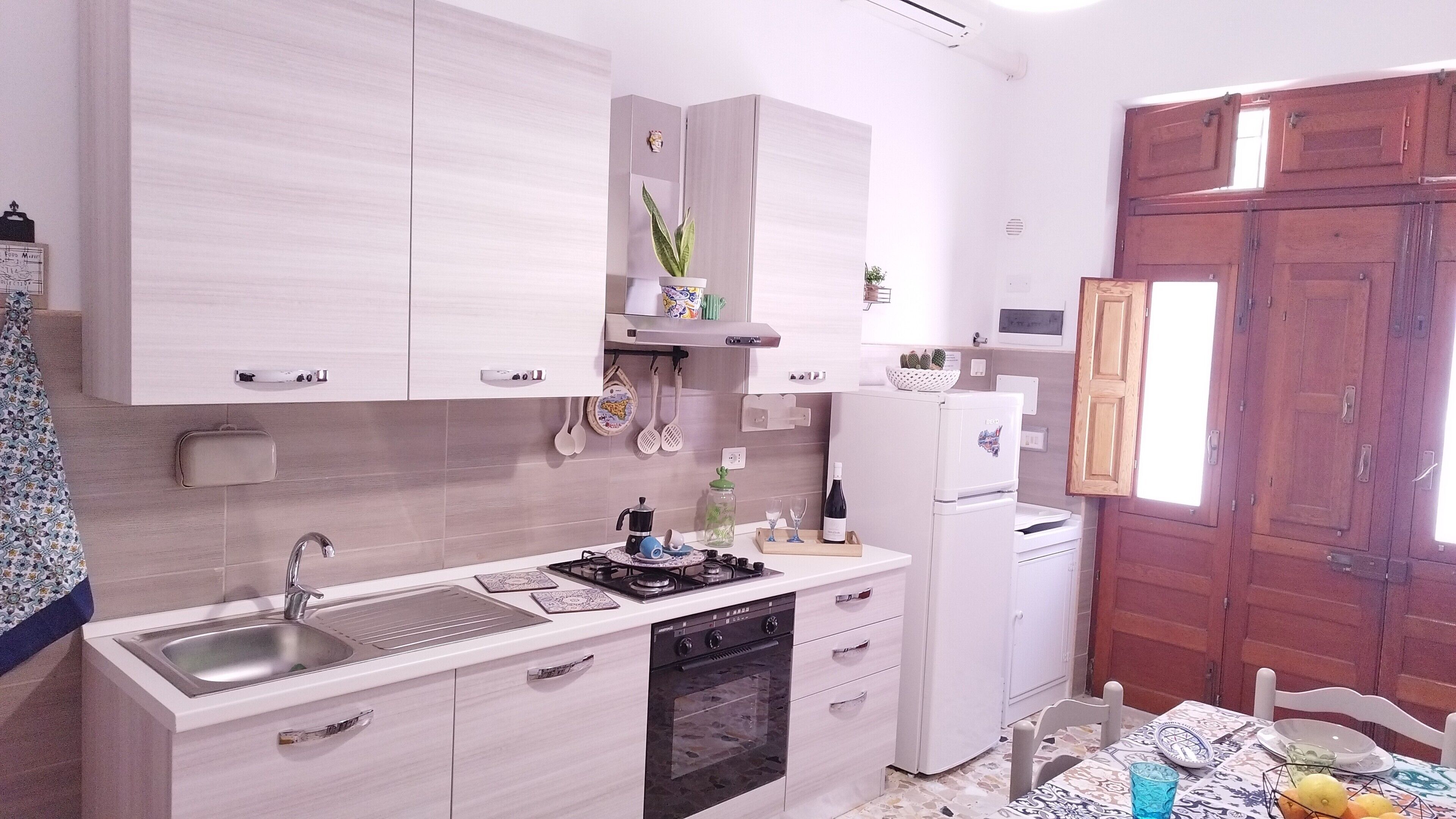 Fridge, coffee/tea maker, cookware/dishes/utensils, spices