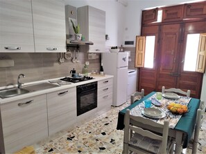 Fridge, coffee/tea maker, cookware/dishes/utensils, spices