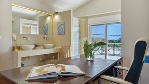 A modern bathroom with a large mirror, two sinks, and a view of the outdoors. - First Floor Master Bedroom with Shared Terrace, Wi-Fi and Air Conditioning (????????S)