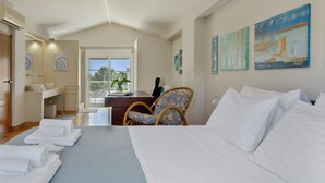A hotel room with a bed, a desk, a chair, a bathroom, and artwork on the walls. - First Floor Master Bedroom with Shared Terrace, Wi-Fi and Air Conditioning (????????S)