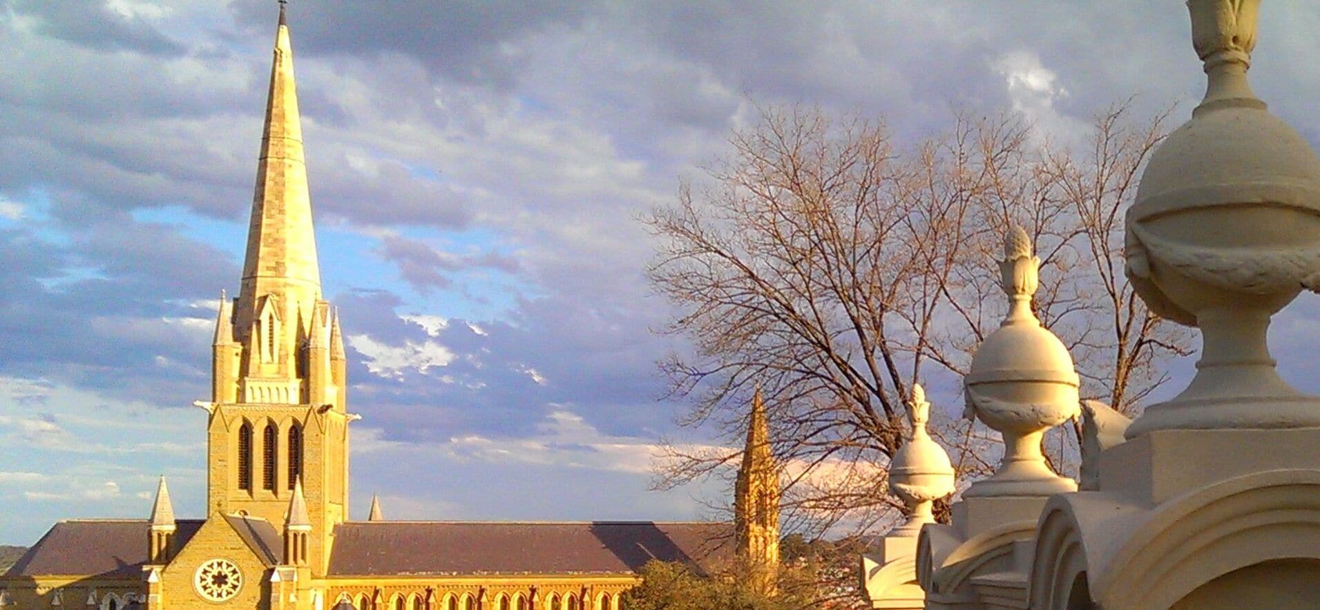 A church with a tall spire and a clock tower.